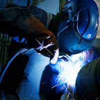 Learn more how Gentex's experience can work for you | decorative photo of a welder at work