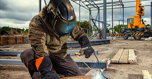 Fully Compliant | decorative image of the ALPHA helmet being held by hands.